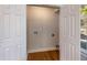 Open laundry room closet with hardwood floors and a washer and dryer hook up at 2562 Tritt Springs Ne Trce, Marietta, GA 30062