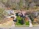 Aerial view of a neighborhood showcasing well-manicured lawns, mature trees, and surrounding streets at 2724 Long Lake Ne Dr, Roswell, GA 30075