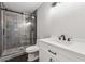 Bathroom featuring a tiled shower with glass doors, modern fixtures, and a vanity at 2724 Long Lake Ne Dr, Roswell, GA 30075