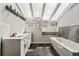 Bright bathroom with double sinks, a soaking tub, and ample counter space at 2724 Long Lake Ne Dr, Roswell, GA 30075
