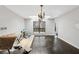 Formal dining room with hardwood floors, a modern chandelier, and natural light at 2724 Long Lake Ne Dr, Roswell, GA 30075