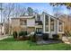 Contemporary two-story home with stone accents, a manicured lawn, and unique architectural details at 2724 Long Lake Ne Dr, Roswell, GA 30075