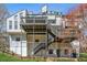 Multi-level home with a series of decks and staircases, blending indoor and outdoor living at 2724 Long Lake Ne Dr, Roswell, GA 30075