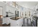 Well-lit kitchen featuring white cabinets, an island, and stainless steel appliances at 2724 Long Lake Ne Dr, Roswell, GA 30075