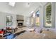Sunlit living room with a stone fireplace, large windows, and a vaulted ceiling at 2724 Long Lake Ne Dr, Roswell, GA 30075
