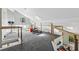Spacious loft with carpeted floor and wood beam railing at 2724 Long Lake Ne Dr, Roswell, GA 30075
