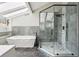 Modern bathroom with a freestanding tub, a glass-enclosed shower, and sleek tile work at 2724 Long Lake Ne Dr, Roswell, GA 30075