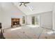 Bedroom with a fireplace, skylight, vaulted ceiling, and access to a private balcony at 2724 Long Lake Ne Dr, Roswell, GA 30075