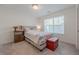 Cozy bedroom features neutral carpet, a window letting in natural light, with floral bedding at 4565 Sims Park Overlook, Suwanee, GA 30024