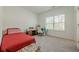 Bright bedroom features neutral carpet, a window letting in natural light, and includes a desk and chair at 4565 Sims Park Overlook, Suwanee, GA 30024