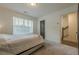 This bedroom features a window and a glimpse into the stairway at 4565 Sims Park Overlook, Suwanee, GA 30024
