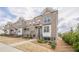 Charming row of two-story brick townhomes with well-maintained lawns and inviting curb appeal at 4565 Sims Park Overlook, Suwanee, GA 30024