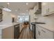 Open-concept kitchen with stainless appliances, island bar, and a seamless flow to the living area at 4565 Sims Park Overlook, Suwanee, GA 30024