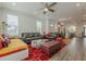 Spacious living room with contemporary furnishings, large windows, and an open view to the kitchen and dining area at 4565 Sims Park Overlook, Suwanee, GA 30024