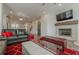 Comfortable living room with a stone fireplace, mounted TV, and stylish seating, with a clear view to the kitchen at 4565 Sims Park Overlook, Suwanee, GA 30024