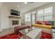 Bright living room featuring a stone fireplace, pendant chair, and large windows for an inviting atmosphere at 4565 Sims Park Overlook, Suwanee, GA 30024