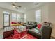 Bright living room featuring large windows, comfortable seating, and stylish decor with a red patterned rug at 4565 Sims Park Overlook, Suwanee, GA 30024