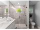 Bright bathroom with glass-enclosed shower, white vanity, and modern tiling at 99 Brown Ave, Atlanta, GA 30315