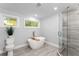 Bright bathroom featuring a modern glass walk-in shower and freestanding soaking tub at 99 Brown Ave, Atlanta, GA 30315