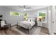 Bedroom with wood floors, windows with natural light, neutral-toned walls, and soft, plush bedding at 99 Brown Ave, Atlanta, GA 30315