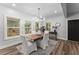 Well-lit dining room features modern chandelier, hardwood floors, and large windows for a bright and inviting atmosphere at 99 Brown Ave, Atlanta, GA 30315