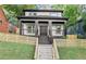 Charming two-story home boasts a welcoming front porch, modern design, and manicured lawn, perfect for suburban living at 99 Brown Ave, Atlanta, GA 30315