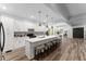 Spacious open kitchen boasts a large island with seating, stainless steel appliances, and flows to the dining area at 99 Brown Ave, Atlanta, GA 30315