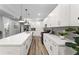 Modern kitchen features a large island with seating, quartz countertops, stainless appliances, and ample cabinet space at 99 Brown Ave, Atlanta, GA 30315