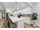 Modern kitchen boasts white cabinets, stone countertops, stainless steel appliances, and a large island with seating at 99 Brown Ave, Atlanta, GA 30315