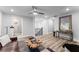 Bright living room with modern decor, wood floors, ceiling fan, and a view of the luxurious tiled shower at 99 Brown Ave, Atlanta, GA 30315