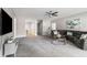 Spacious living room with gray carpet, a ceiling fan, and modern decor at 111 Franklin Rd, Woodstock, GA 30188