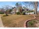 Landscaped yard featuring a white picket fence, arbor and mature trees at 3855 Cohutta Pass, Marietta, GA 30062