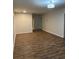 Spacious living room features modern lighting, neutral color palette, and wood-look floors at 1076 Grant Se Way, Atlanta, GA 30315
