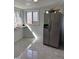 Sun room featuring stainless steel refrigerator, tiled floor, desk and ample lighting at 1076 Grant Se Way, Atlanta, GA 30315