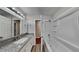 Modern bathroom featuring granite countertops, a tub and shower combination at 1809 Fairpointe Trce, Stone Mountain, GA 30088