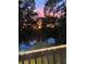 Backyard view featuring a green lawn, trees, and a shed against a colorful sunset backdrop at 2795 Kimmeridge Dr, Atlanta, GA 30344