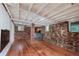 Rustic basement featuring exposed brick and stone, wooden floors, and a bar area at 2795 Kimmeridge Dr, Atlanta, GA 30344