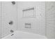 Bathroom with white subway tile, shower head, and built in shelves at 2795 Kimmeridge Dr, Atlanta, GA 30344