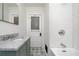 Bathroom features a shower with white subway tiles, marble countertop, and decorative floor tiling at 2795 Kimmeridge Dr, Atlanta, GA 30344