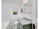 Bathroom with marble countertop vanity, decorative tile, and natural light at 2795 Kimmeridge Dr, Atlanta, GA 30344