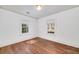 Bright bedroom with hardwood floors featuring two windows letting in ample natural light at 2795 Kimmeridge Dr, Atlanta, GA 30344