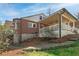Exterior home view showcasing a covered deck, brick accents, stone foundation, and a landscaped backyard at 2795 Kimmeridge Dr, Atlanta, GA 30344