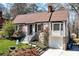 Charming brick home featuring landscaped front yard, gabled roof, and attached one-car garage at 2795 Kimmeridge Dr, Atlanta, GA 30344