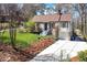 Wide shot of a charming brick home with a well-maintained lawn, long driveway, and mature trees at 2795 Kimmeridge Dr, Atlanta, GA 30344