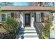 Inviting front entrance with brick facade, well-manicured landscaping and wrought iron railing at 2795 Kimmeridge Dr, Atlanta, GA 30344