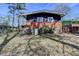 Backyard featuring a brick foundation with a door, an overgrown lawn, and mature trees at 3007 Pasadena Dr, Decatur, GA 30032