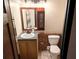 Bathroom featuring a wooden vanity and mirror over the sink, and a white toilet at 3007 Pasadena Dr, Decatur, GA 30032