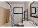 Bathroom featuring a shower with decorative curtain, white sink and rustic mirror frame at 3007 Pasadena Dr, Decatur, GA 30032