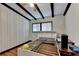 Empty bedroom showing hardwood floors, white-paneled walls, black ceiling beams and natural light at 3007 Pasadena Dr, Decatur, GA 30032
