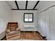Bedroom featuring hardwood floors, white walls, black beams, vintage area rug and a lounge chair at 3007 Pasadena Dr, Decatur, GA 30032
